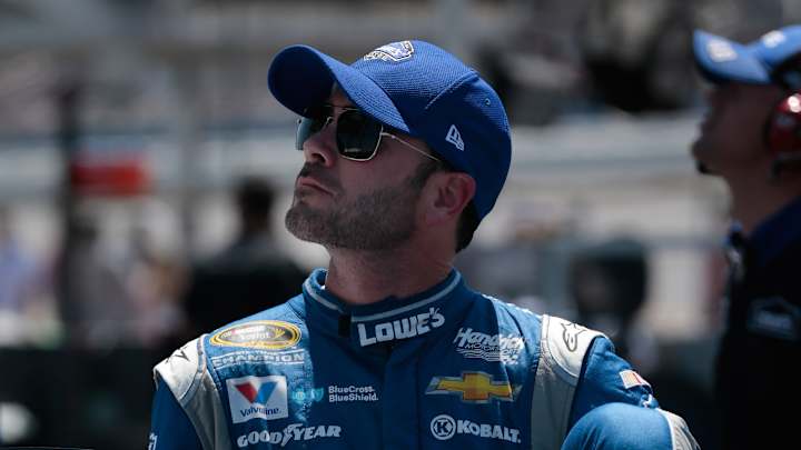 Johnson stays on track during late caution, wins at Kansas