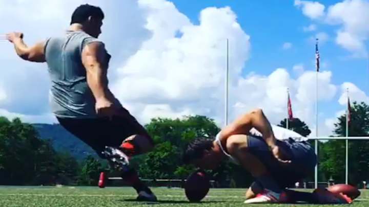 Wisconsin kicker has holder hold football with nose for kick