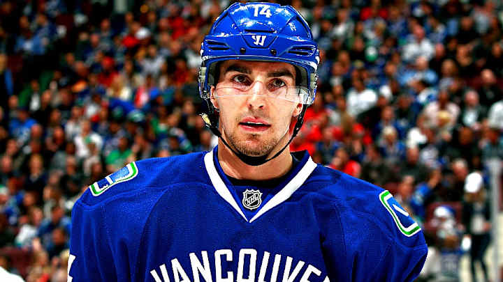 Canucks' Alex Burrows leaves practice in ambulance, out for Game 4