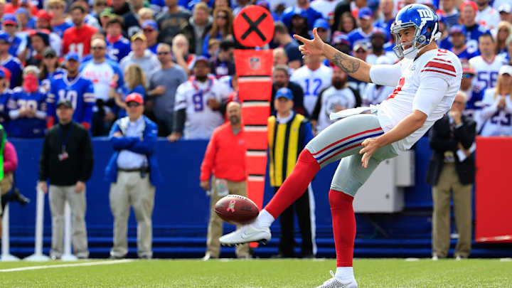 New York Giants P Brad Wing celebrates punt with golf swing