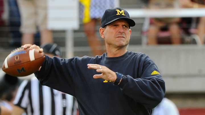 Jim Harbaugh warmed up with Michigan’s players before Utah game Jim Harbaugh warmed up with Michigan’s players before Utah game