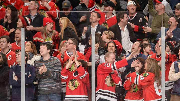 Watch: Blackhawks fan gets cut on head by glass, keeps watching game
