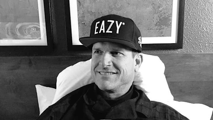 Here's a picture of Jim Harbaugh wearing a hat given to him by a rapper Here's a picture of Jim Harbaugh wearing a hat given to him by a rapper
