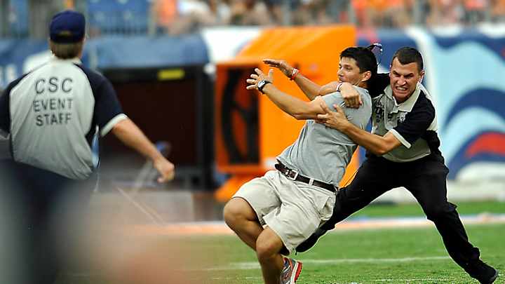 Security grabs fan who ran on field during weather delay