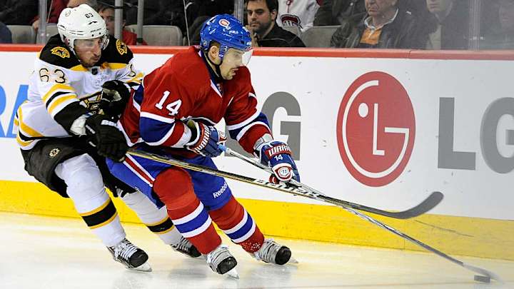 Canadiens' Tomas Plekanec returns dig from Brad Marchand of Bruins