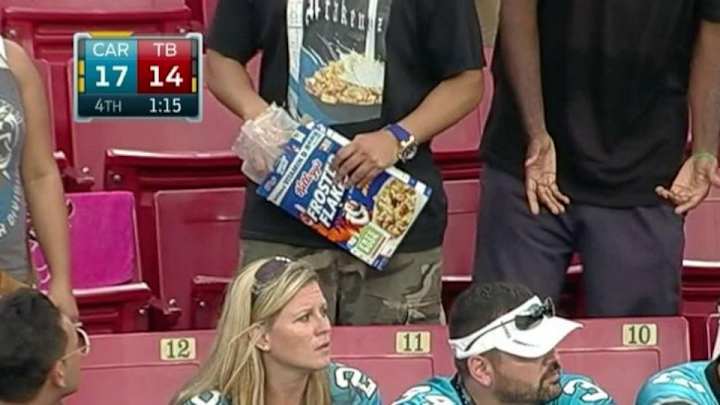 Buccaneers fan in a cereal T-shirt brought a box of cereal into the game