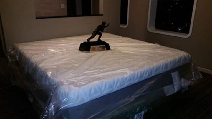 Johnny Manziel shows off new mattress/Heisman holder Johnny Manziel shows off new mattress/Heisman holder
