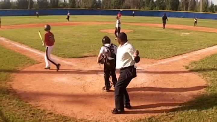 Little League umpire in the Bahamas dances in between pitches