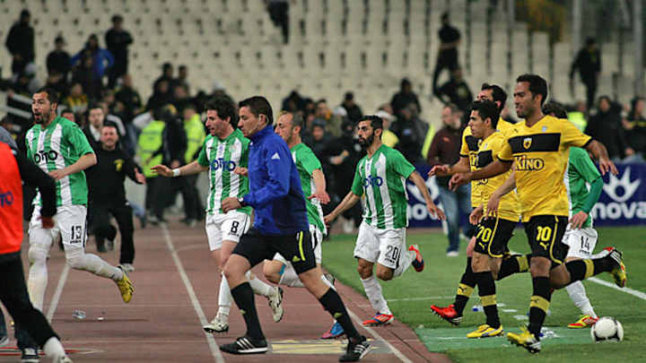 AEK Athens players chased off pitch by angry fans