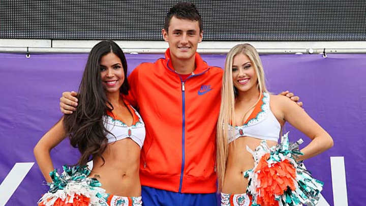 Bernard Tomic has some fun with Miami Dolphins cheerleaders