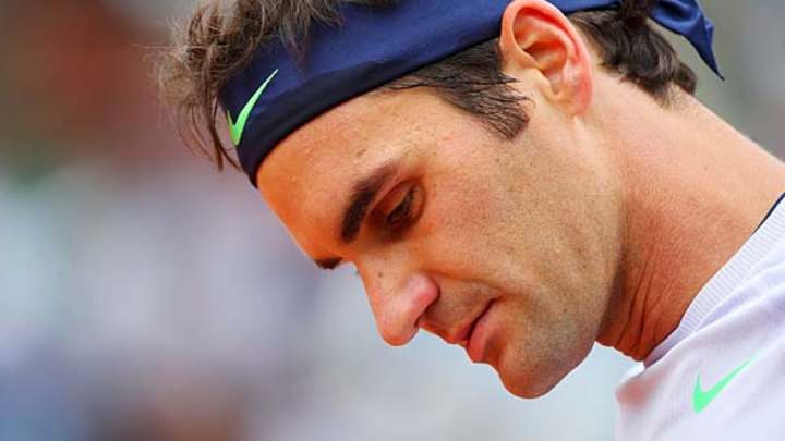 Roger Federer goes around the post for winner against Gilles Simon