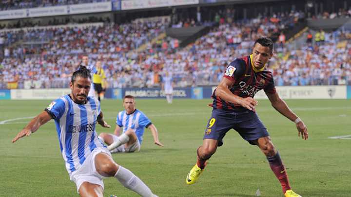 Adriano rescues Barcelona in win over Malaga