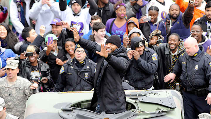 Fans march with Baltimore Ravens' parade to packed stadium