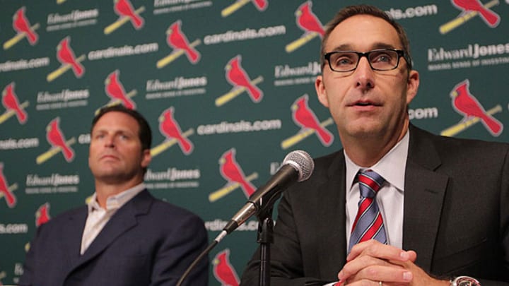 Cardinals extend GM's contract, pick up Matheny's option