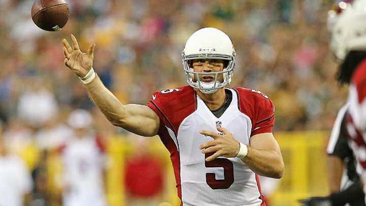 Arizona Cardinals' Drew Stanton trips trying to evade the rush, goes down hard