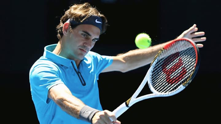 Federer shakes off rust, eases into second round