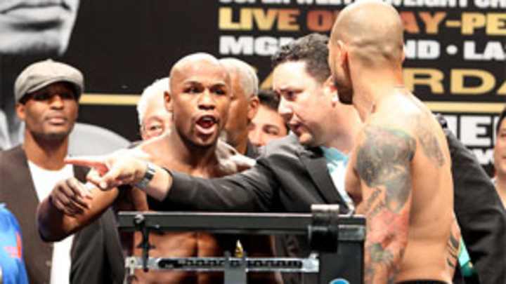 Floyd Mayweather, Miguel Cotto exchange words at weigh-in