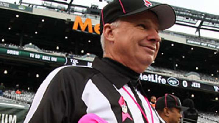 Fan, 11, presents Goodell with pink penalty flags