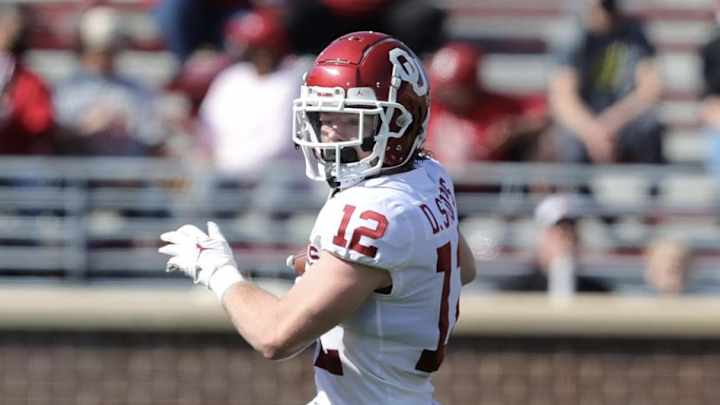 Oklahoma teammates cheer Drake Stoops Oklahoma teammates cheer Drake Stoops