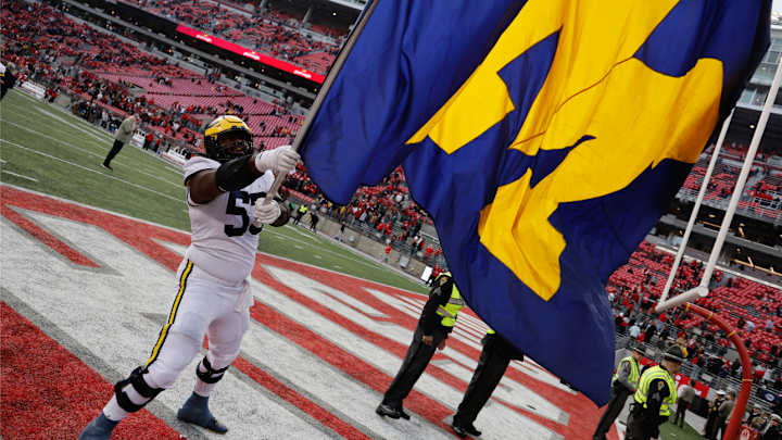 Michigan Players Plant Team's Flag at Midfield of Ohio Stadium