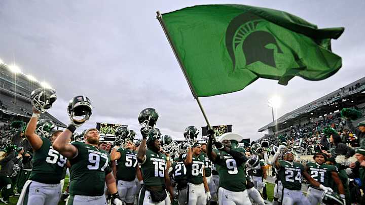 Michigan State Fans Get Into Snowball Fight in Stands During Game (Video)