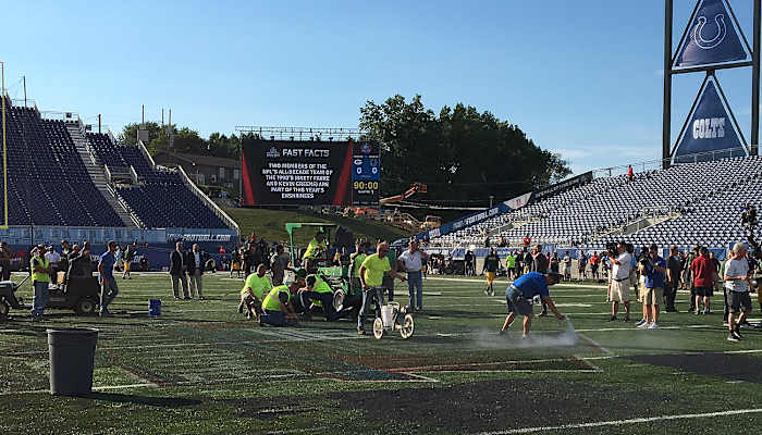 Field maintenance workers scrambled to get the turf ready for Sunday night’s game, which ultimately was cancelled due to unsafe playing conditions.