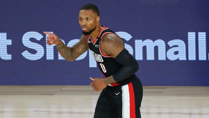 Portland Trail Blazers guard Damian Lillard (0) reacts after making a three point basket against the Dallas Mavericks during the second half of a NBA game at The Field House.