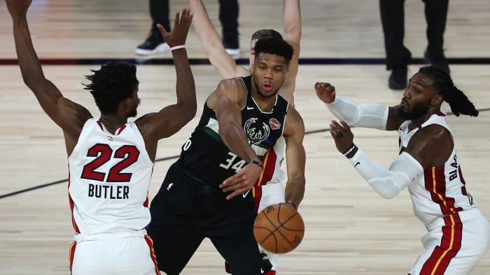 Milwaukee Bucks forward Giannis Antetokounmpo passes the ball against Miami Heat forward Jimmy Butler.