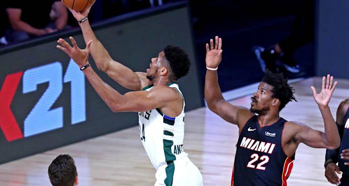 Milwaukee Bucks forward Giannis Antetokounmpo (34) shoots the ball against Miami Heat forward Jimmy Butler (22)