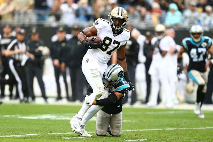 Dec 29, 2019; Charlotte, North Carolina, USA; New Orleans Saints tight end Jared Cook (87) gets tackled by Carolina Panthers cornerback Javien Elliott (23) during the second quarter at Bank of America Stadium. Mandatory Credit: Jeremy Brevard-USA TODAY