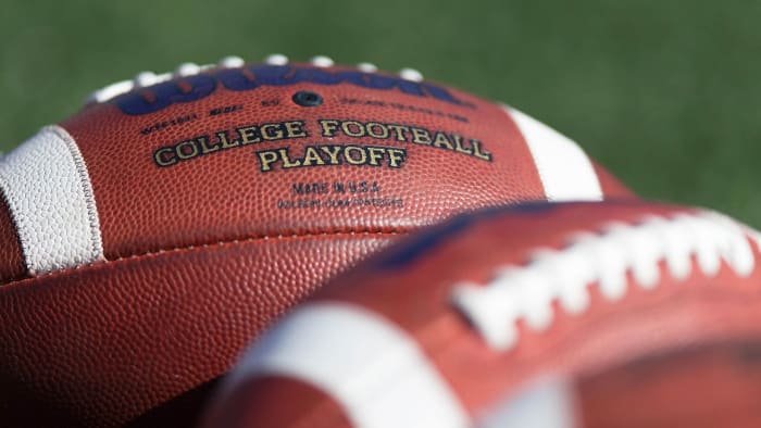 'College Football Playoff' is printed on a soccer ball