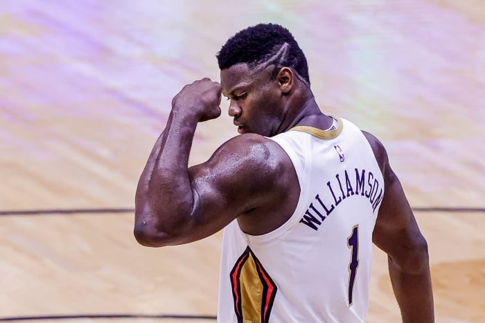 New Orleans Pelicans forward Zion Williamson flexes his arm muscles after taking a shot.