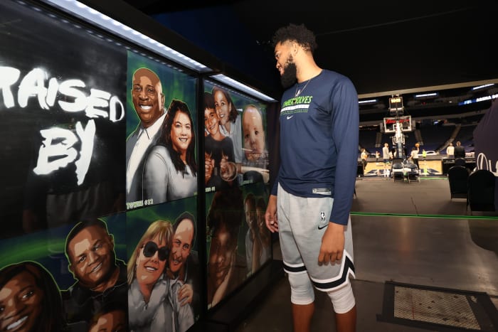Karl-Anthony Towns looking at a mural