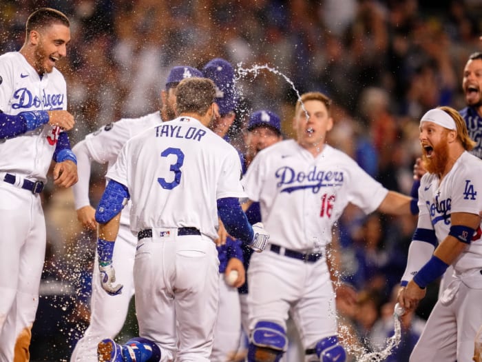The Los Angeles Dodgers celebrate left fielder Chris Taylor's (3) two-run home run against the St. Louis Cardinals during the ninth inning at Dodger Stadium.  Los Angeles Dodgers
