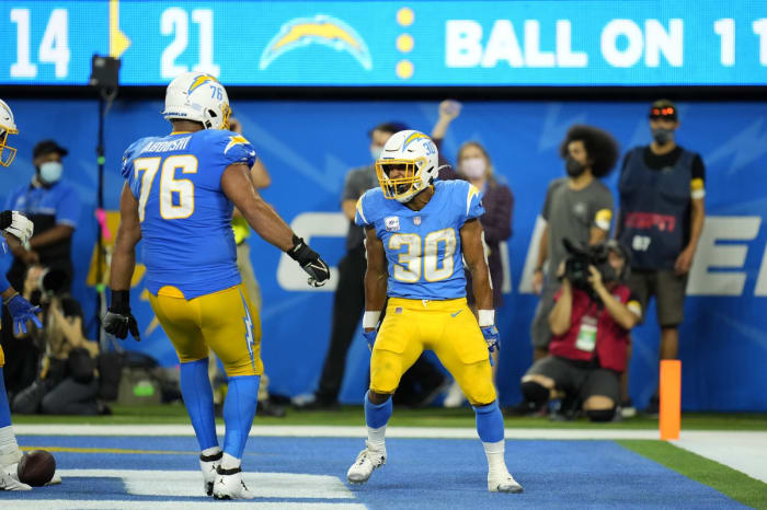 October 4, 2021;  Inglewood, California, USA;  Los Angeles Chargers running back Austin Ekeler (30) celebrates with offensive guard Oday Aboushi (76) after scoring a touchdown against the Las Vegas Raiders in the second half at SoFi Stadium.  Mandatory Credit: Robert Hanashiro-USA TODAY Sports