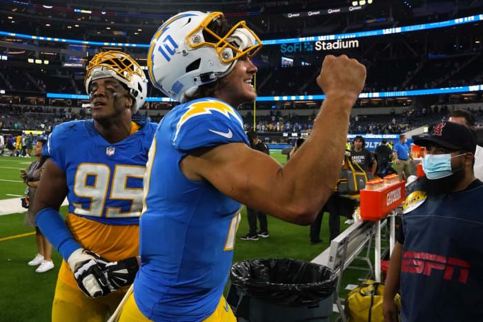 October 4, 2021;  Inglewood, California, USA;  Los Angeles Chargers quarterback Justin Herbert (10) and defensive end Christian Covington (95) react after defeating the Las Vegas Raiders at SoFi Stadium.  Mandatory Credit: Kirby Lee-USA TODAY Sports