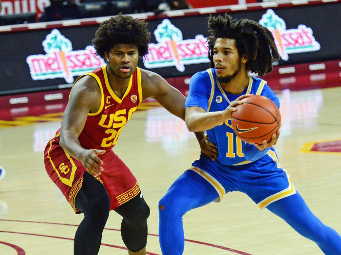 UCLA's Tyger Campbell goes against USC's Ethan Anderson