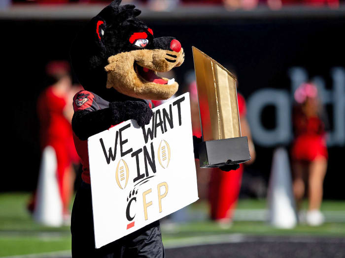 Cincinnati's mascot holds up a sign saying the Bearcats want in the College Football Playoff
