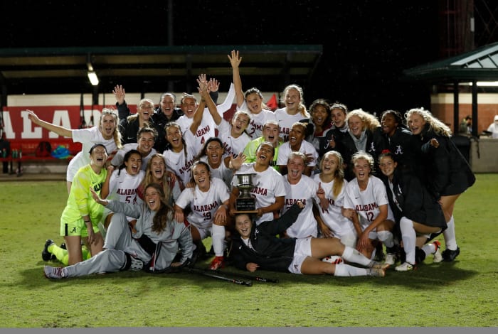 Alabama soccer with the Iron Bowl trophy