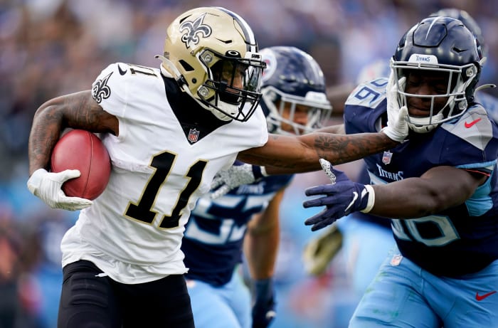 New Orleans Saints wide receiver Deonte Harris (11) keeps Tennessee Titans linebacker Monty Rice (56) at arms length during the second quarter at Nissan Stadium Sunday, Nov. 14, 2021 in Nashville, Tenn.  Titans Saints 2558