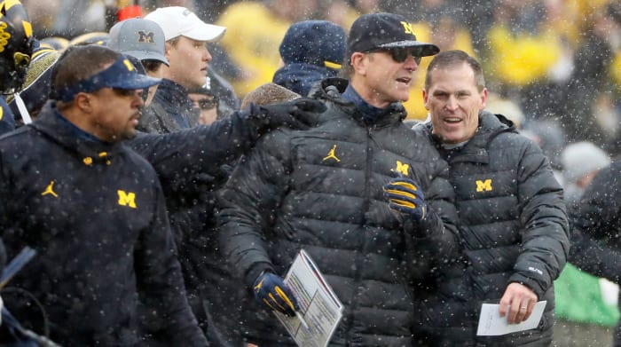 Michigan Wolverines head coach Jim Harbaugh celebrates on the bench after defeating Ohio State Buckeyes 42-27 in NCAA college football at Michigan Stadium in Ann Arbor, Michigan on November 27, 2021. Osu21um Kwr 34
