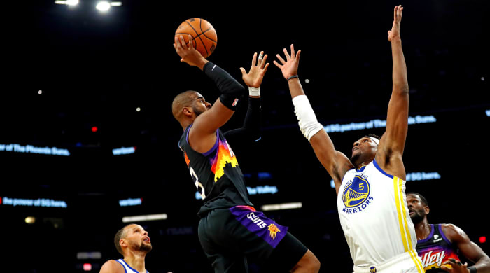 Phoenix, Arizona, United States;  Phoenix Suns guard Chris Paul (3) shoots the ball against Golden State Warriors center Kevon Looney (5) during the second quarter at the Footprint Center.  Mandatory Credit: Mark J. Rebilas-USA TODAY Sports