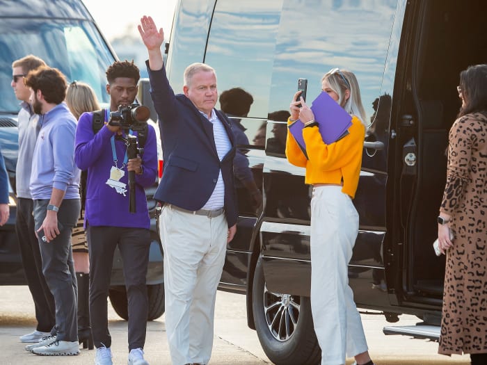 Brian Kelly waves upon his arrival in Baton Rouge