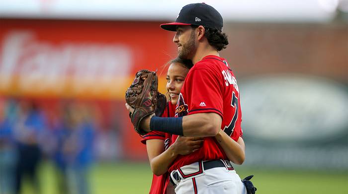 Aug 30, 2019; Atlanta, GA, USA; United States women s national team forward Mallory Pugh (left) hugs Atlanta Braves shortstop Dansby Swanson (7) before a game against the Chicago White Sox at SunTrust Park.