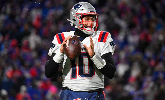 New England Patriots quarterback Mac Jones (10) warms up on the field during a time-out against the Buffalo Bills in the second half at Highmark Stadium.