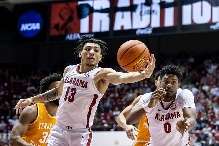 Alabama guard Jahvon Quinerly (13) reaches for a rebound against Tennessee during the first half of an NCAA college basketball game, Wednesday, Dec. 29, 2021, in Tuscaloosa, Ala. At right is Alabama forward Noah Gurley.