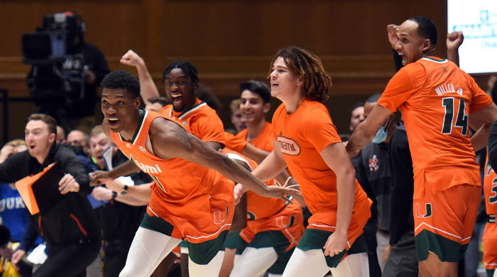 The Miami Hurricanes bench bursts onto the court after defeating the Duke Blue Devils at Cameron Indoor Stadium.