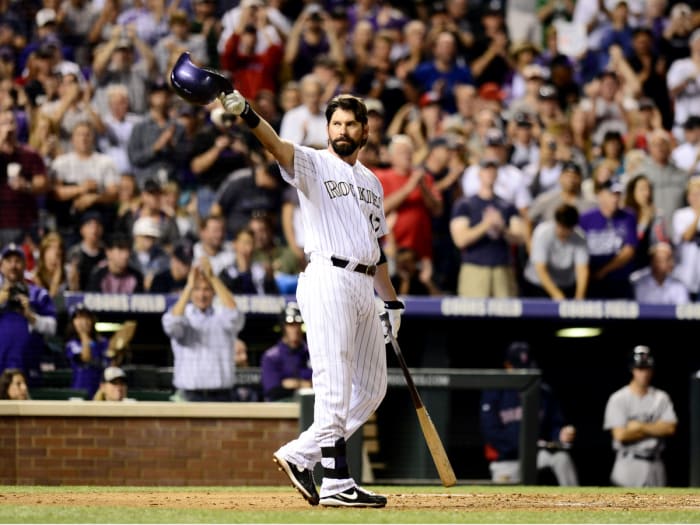 Rockies first baseman Todd Helton knocks off his helmet in the second inning against the Red Sox at Coors Field.