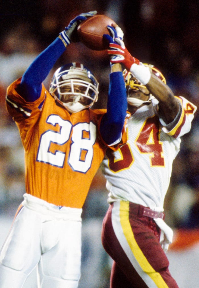 Denver Broncos safety Jeremiah Castille (28) intercepts a pass intended for Washington Redskins receiver Gary Clark (84) during Super Bowl XXII at Jack Murphy Stadium.
