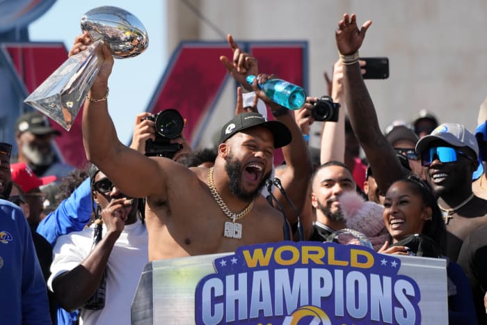 Feb 16, 2022; Los Angeles, CA, USA; Los Angeles Rams defensive end Aaron Donald holds the Vince Lombardi trophy during the Super Bowl LVI championship rally at the Los Angeles Memorial Coliseum. Mandatory Credit: Kirby Lee-USA TODAY Sports